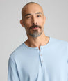 Model wearing a light blue long-sleeve henley.