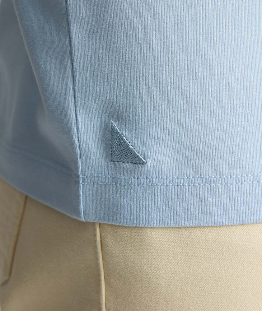 Model wearing a light blue long-sleeve henley.