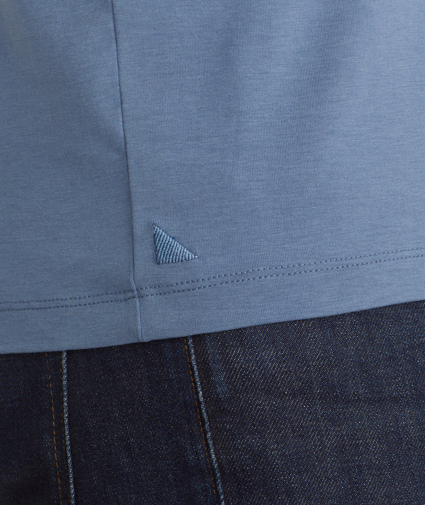 Model is wearing UNTUCKit Marastina henley in blue horizon.