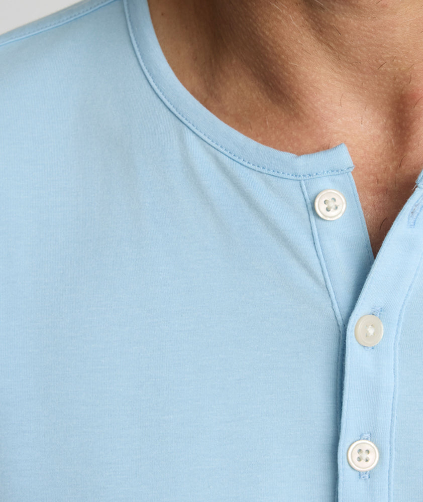 Model is wearing UNTUCKit Marastina LS Tencel Henley in Powder Blue.