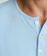 Model is wearing UNTUCKit Marastina LS Tencel Henley in Powder Blue.