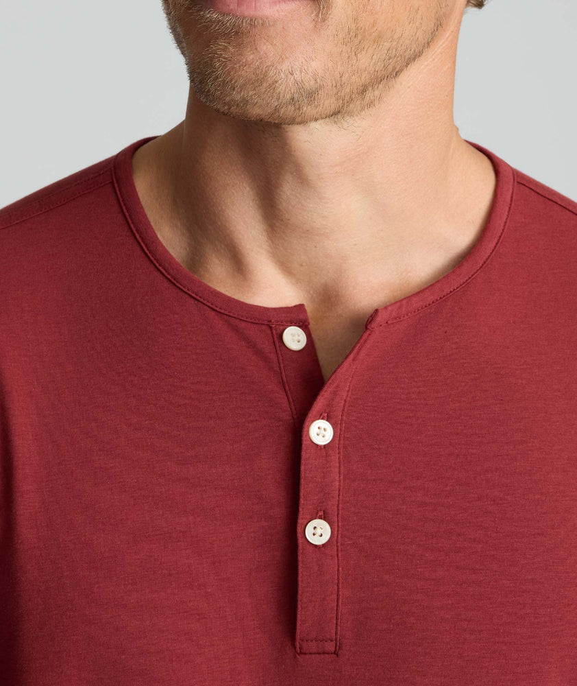Model is wearing UNTUCKit Marastina henley in Chili Oil.
