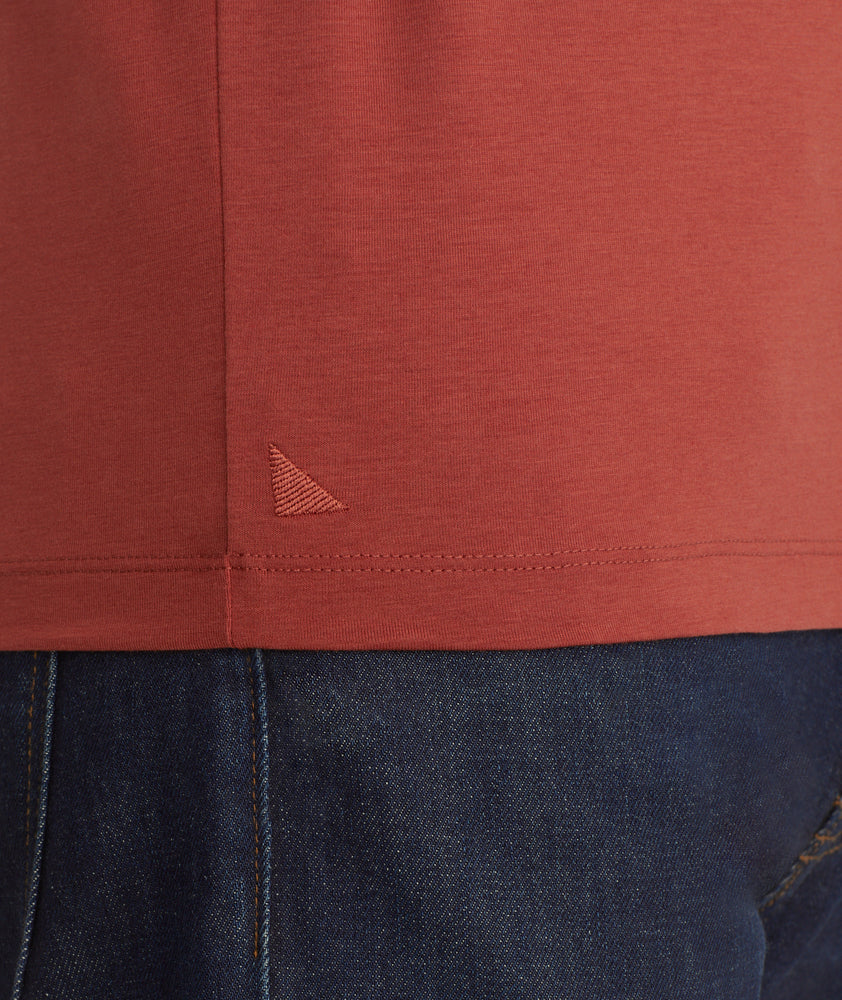 Model is wearing UNTUCKit Marastina henley in Chili Oil.
