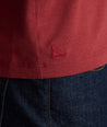 Model is wearing UNTUCKit Marastina henley in Chili Oil.