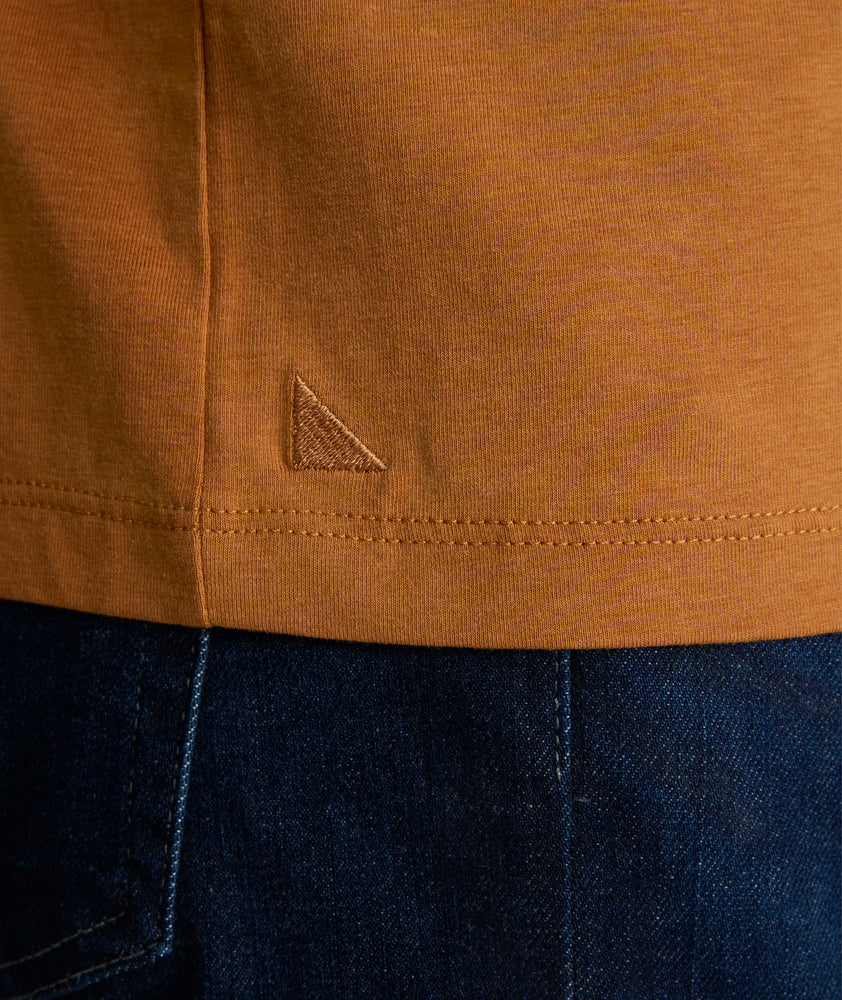 Model is wearing UNTUCKit Marastina LS Tencel Henley in Roasted Pecan.
