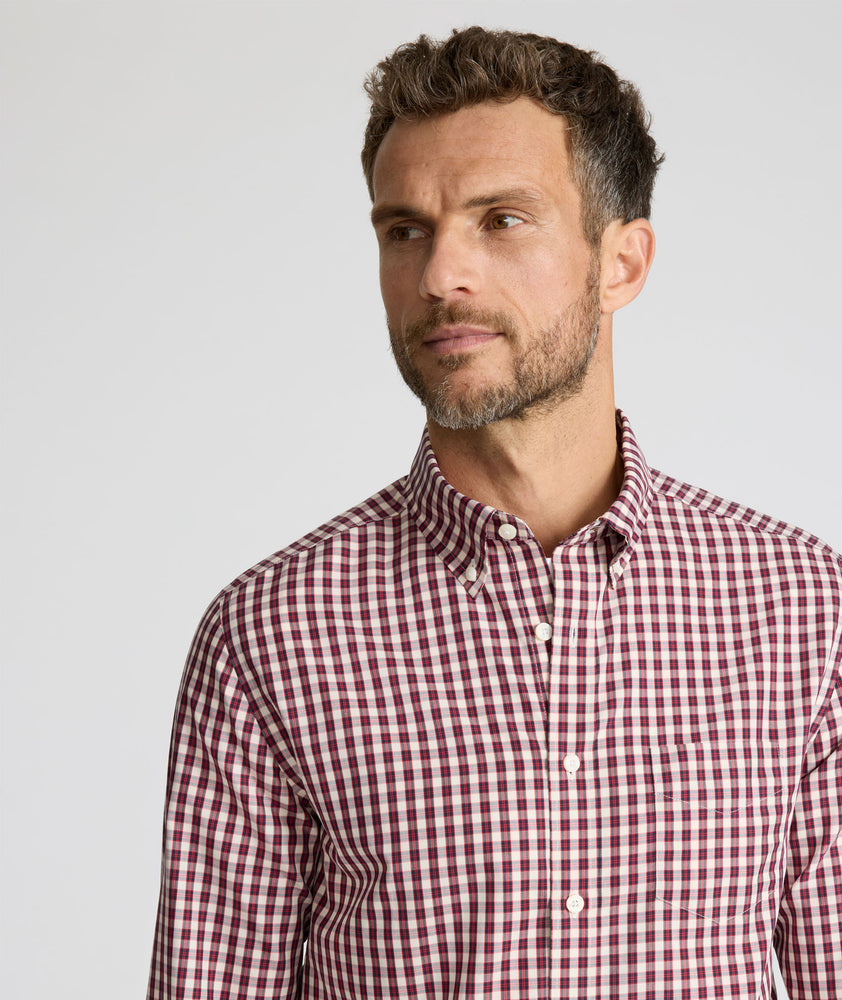 Model wearing a long-sleeve red plaid Wrinkle-Free Shirt.