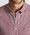 Model is wearing UNTUCKit Wrinkle-Free Marchand Shirt in Black, Red, & White Plaid.