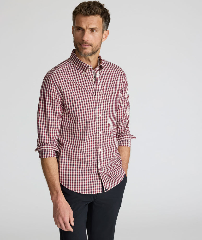 Model wearing a long-sleeve red plaid Wrinkle-Free Shirt.