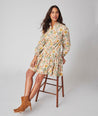 Model is wearing UNTUCKit printed Maren dress.