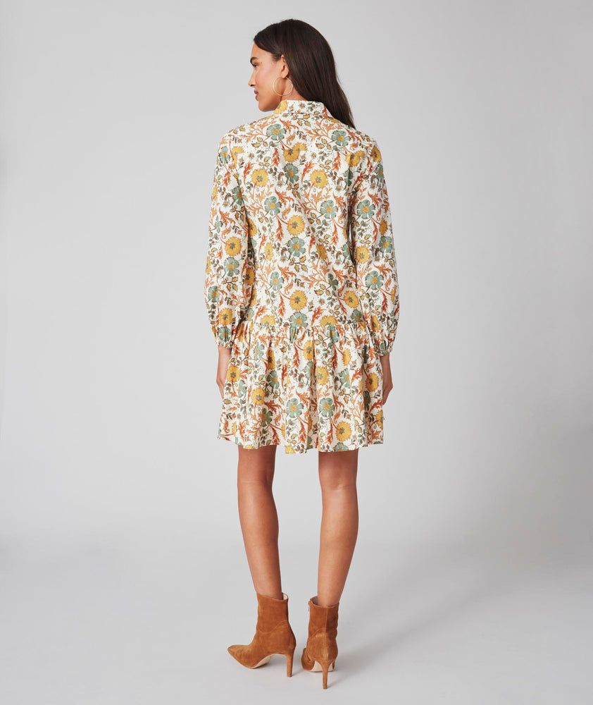 Model is wearing UNTUCKit printed Maren dress.