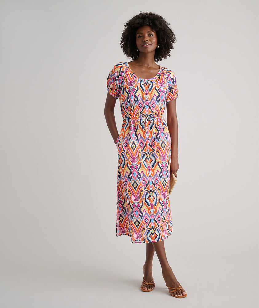 Model is wearing UNTUCKit Marguerite printed orange dress. 