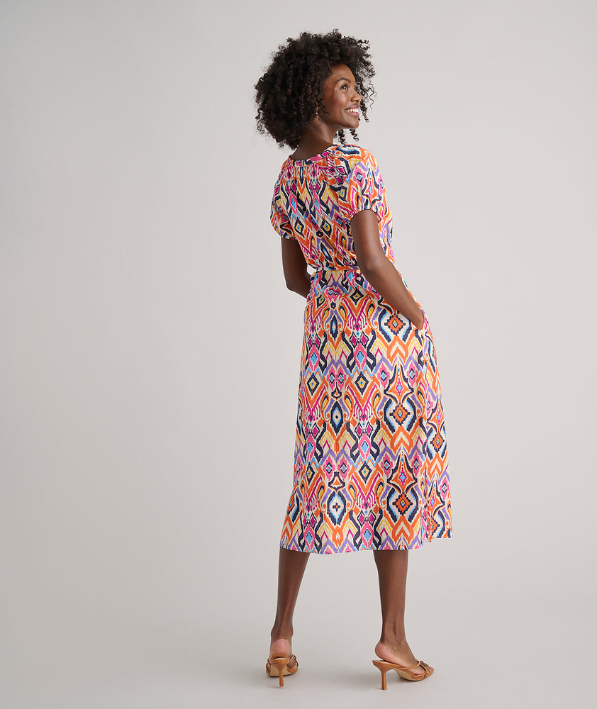 Model is wearing UNTUCKit Marguerite printed orange dress. 