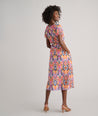 Model is wearing UNTUCKit Marguerite printed orange dress. 