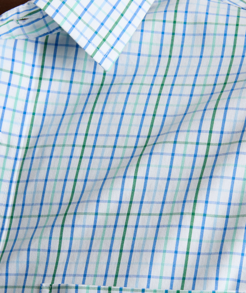 Model is wearing UNTUCKit CottonTek Marten Shirt in blue. 