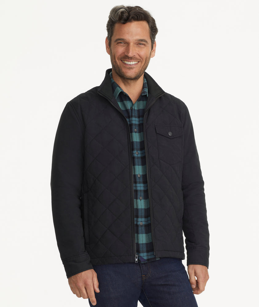 Model is wearing UNTUCKit Marty jacket in black.