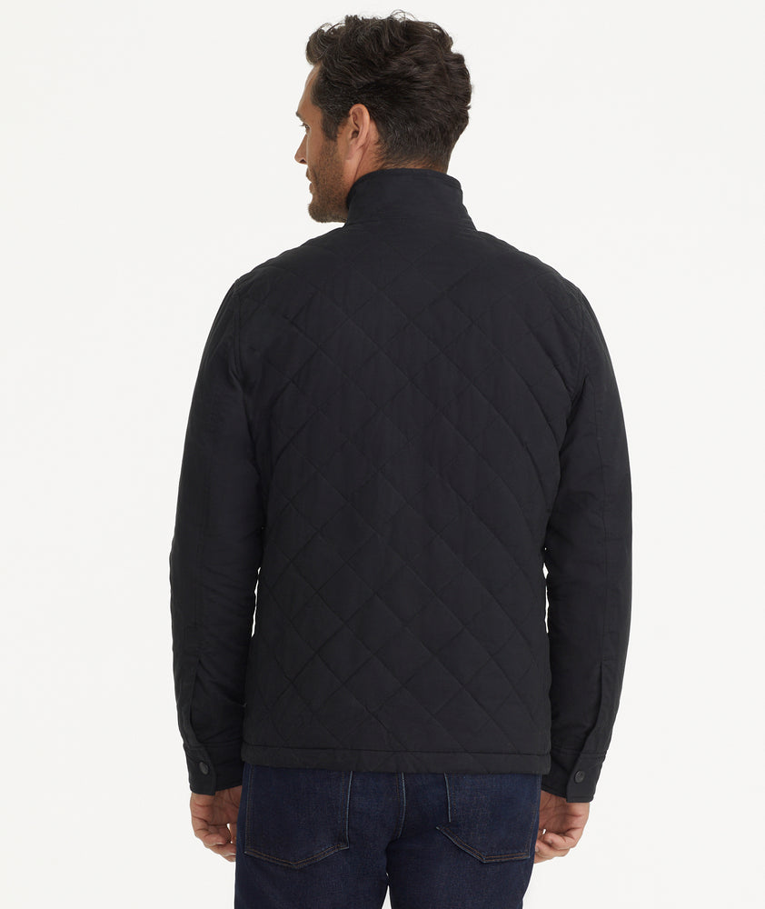 Model is wearing UNTUCKit Marty jacket in black.