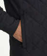 Model is wearing UNTUCKit Marty jacket in black.
