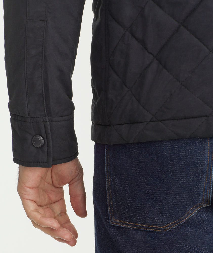Model is wearing UNTUCKit Marty jacket in black.