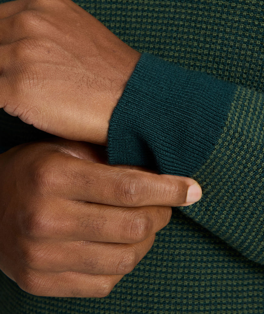 Model is wearing UNTUCKit Textured Merino Wool Quarter-Zips in deep forest. 