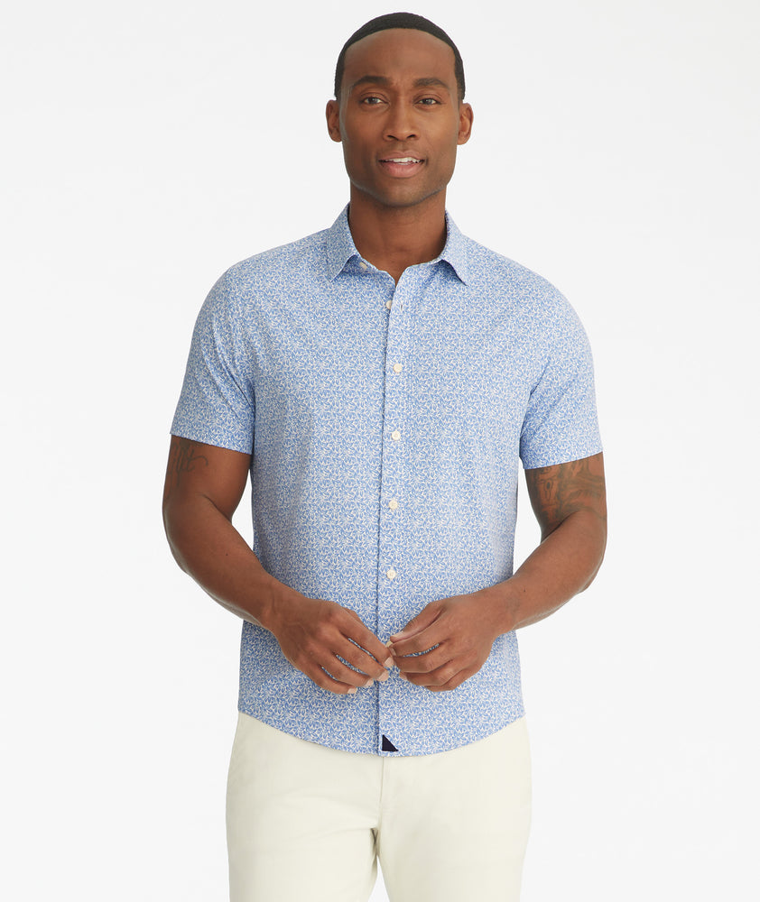 Model is wearing UNTUCKit Mavrud pink short sleeve button down.