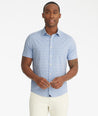 Model is wearing UNTUCKit Mavrud pink short sleeve button down.