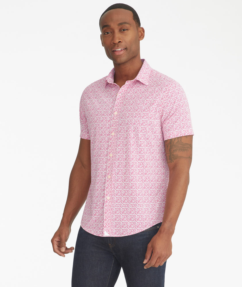 Model is wearing UNTUCKit Mavrud pink short sleeve button down.