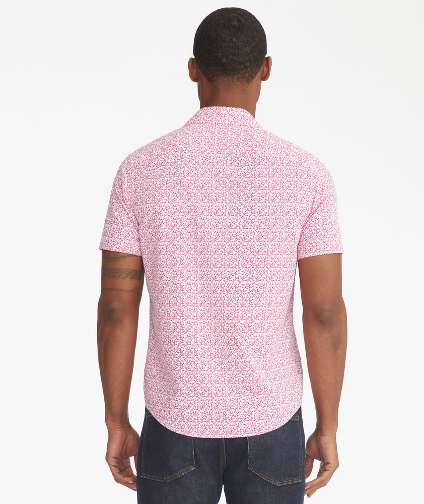 Model is wearing UNTUCKit Mavrud pink short sleeve button down.