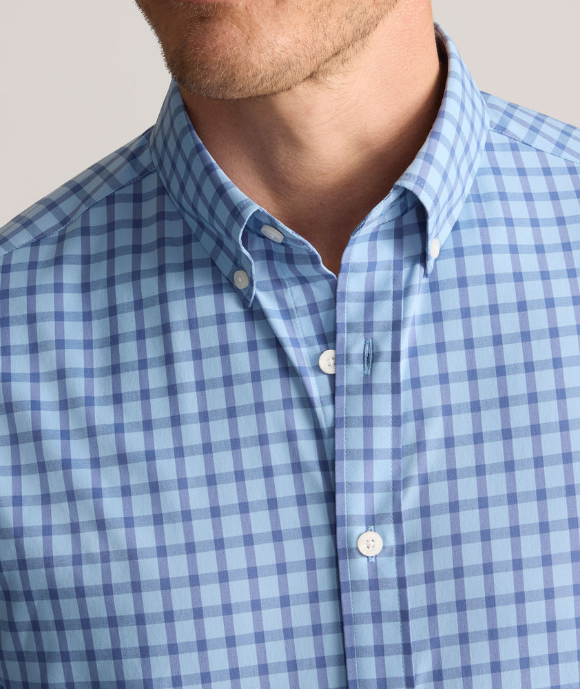 Model is wearing UNTUCKit Performance Mayberry Shirt in Blue Check. 