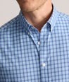 Model is wearing UNTUCKit Performance Mayberry Shirt in Blue Check. 