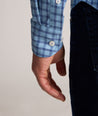 Model is wearing UNTUCKit Performance Mayberry Shirt in Blue Check. 