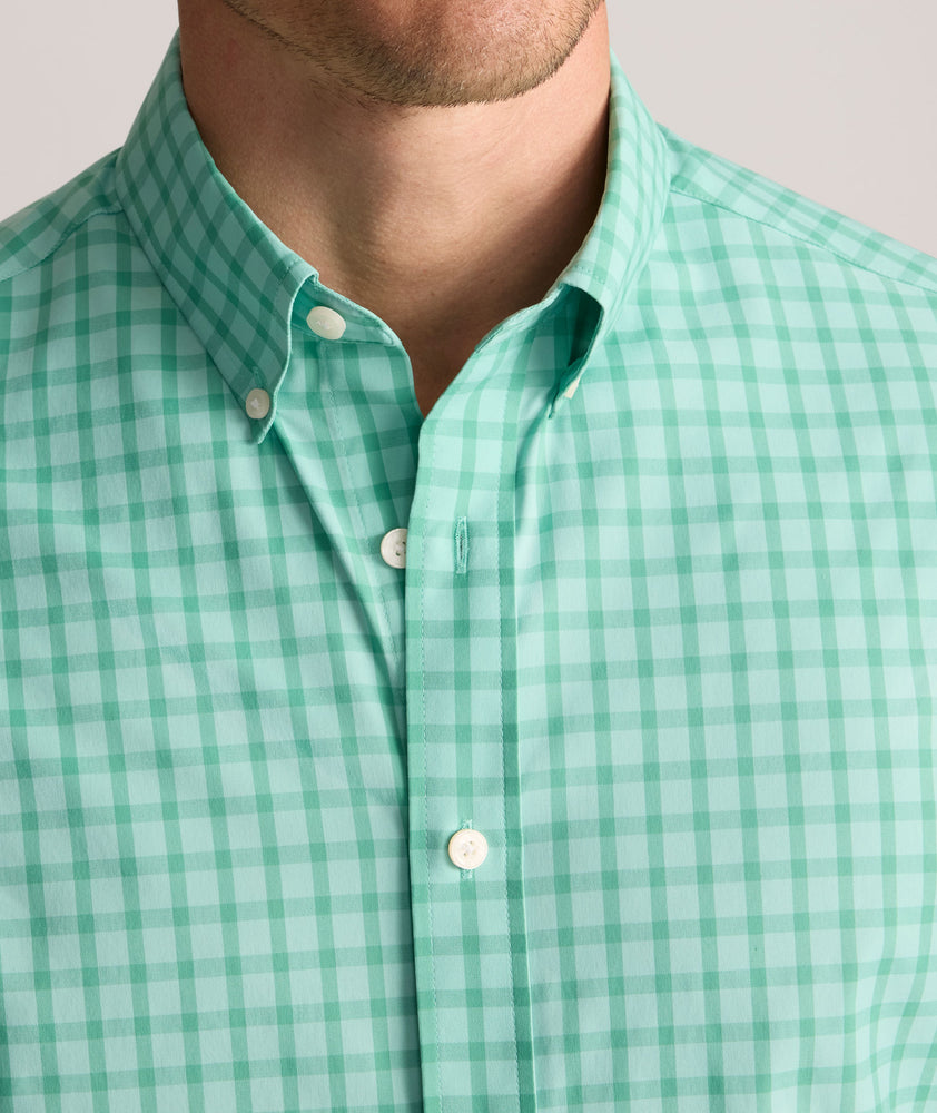 Model is wearing UNTUCKit Performance Mayberry Shirt in green Check. 