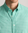 Model is wearing UNTUCKit Performance Mayberry Shirt in green Check. 