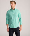 Model is wearing UNTUCKit Performance Mayberry Shirt in green Check. 