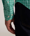 Model is wearing UNTUCKit Performance Mayberry Shirt in green Check. 