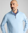Model is wearing UNTUCKit Performance Quarter-Zip in Light Blue. 