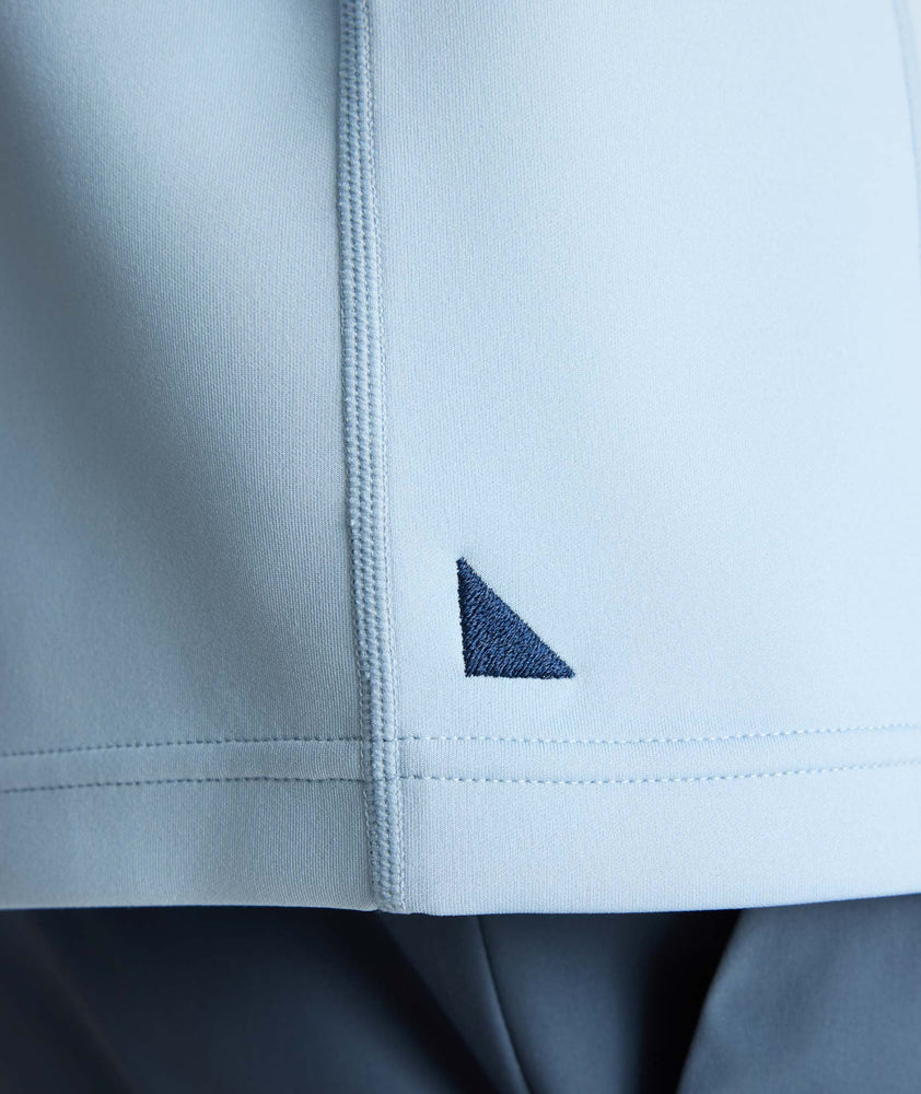 Model is wearing UNTUCKit Performance Quarter-Zip in Light Blue. 