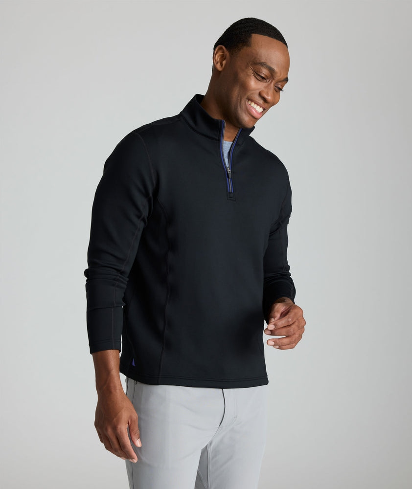 Model wearing a  Performance Quarter-Zip in black.