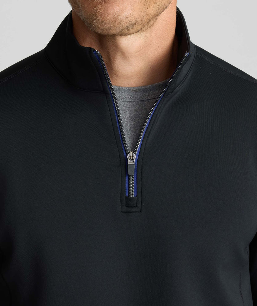 Model wearing a  Performance Quarter-Zip in black.