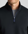 Model wearing a  Performance Quarter-Zip in black.