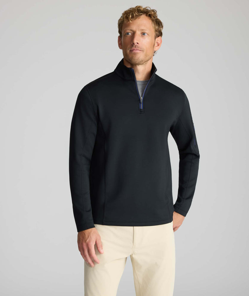 Model wearing a  Performance Quarter-Zip in black.