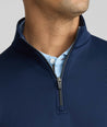 Model is wearing UNTUCKit performance sweatshirt in navy.