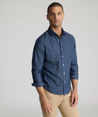 Model is wearing UNTUCKit Mcbride Wrinkle-free shirt in printed chambray. 