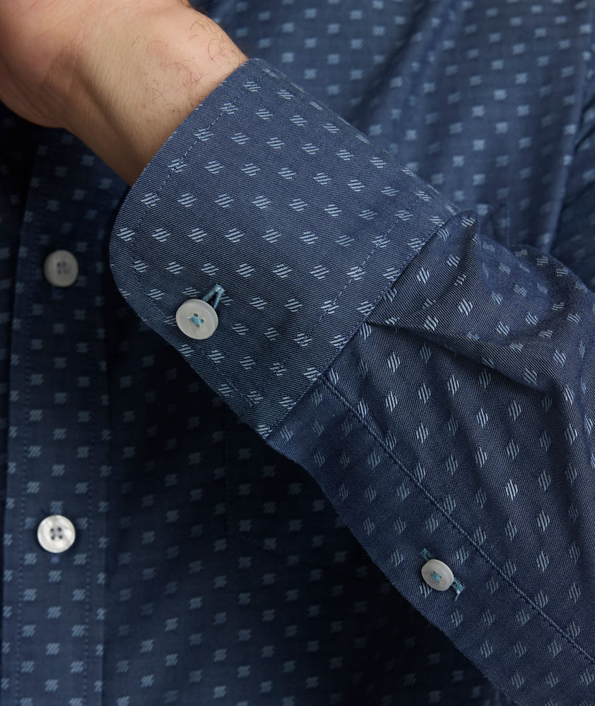 Model is wearing UNTUCKit Mcbride Wrinkle-free shirt in printed chambray. 