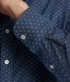 Model is wearing UNTUCKit Mcbride Wrinkle-free shirt in printed chambray. 