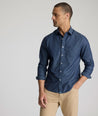 Model is wearing UNTUCKit Mcbride Wrinkle-free shirt in printed chambray. 