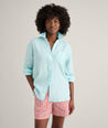 Model is wearing UNTUCKit Wrinkle-Resistant Linen Relaxed Fit Melanie Shirt in blue. 