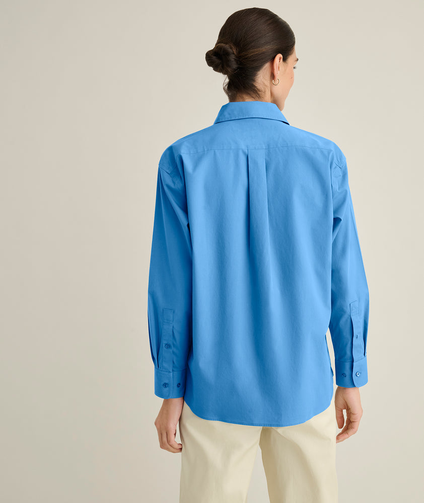 Model is wearing UNTUCKit Melanie shirt in blue. 