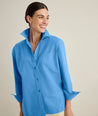 Model is wearing UNTUCKit Melanie shirt in blue. 
