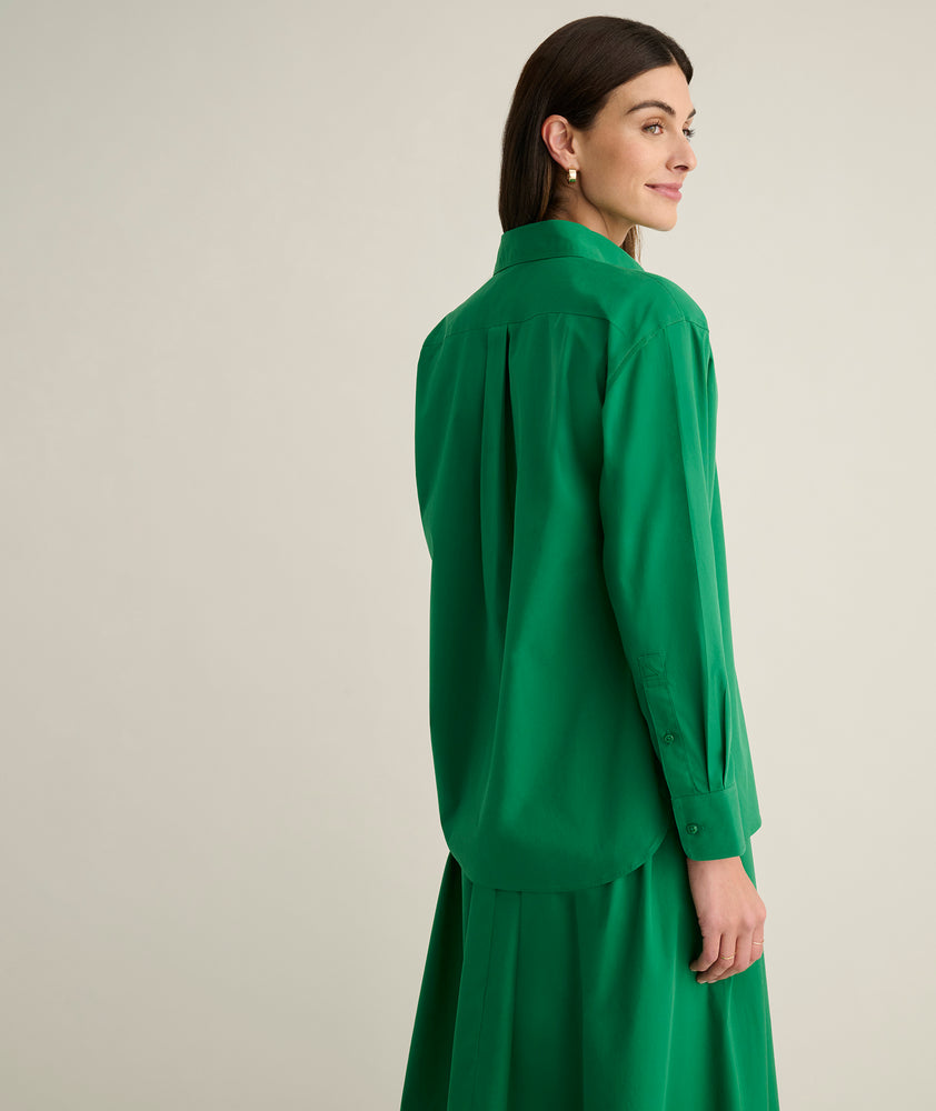 Model is wearing UNTUCKit Melanie shirt in green. 