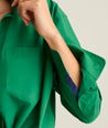 Model is wearing UNTUCKit Melanie shirt in green. 